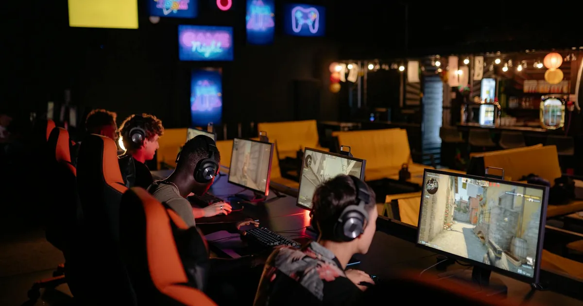 A gamer using a high-speed internet connection, surrounded by gaming gear, highlighting low latency for optimal gaming performance.