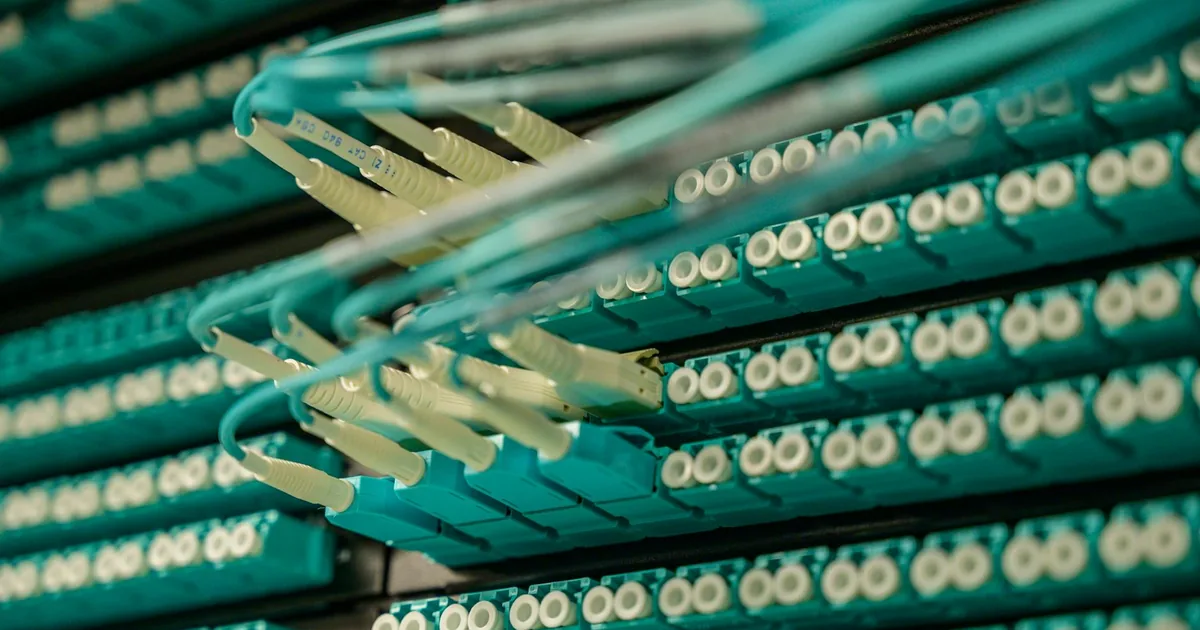Illustration comparing fiber and cable internet, featuring icons of fiber optic cables and coaxial cables with futuristic digital elements.