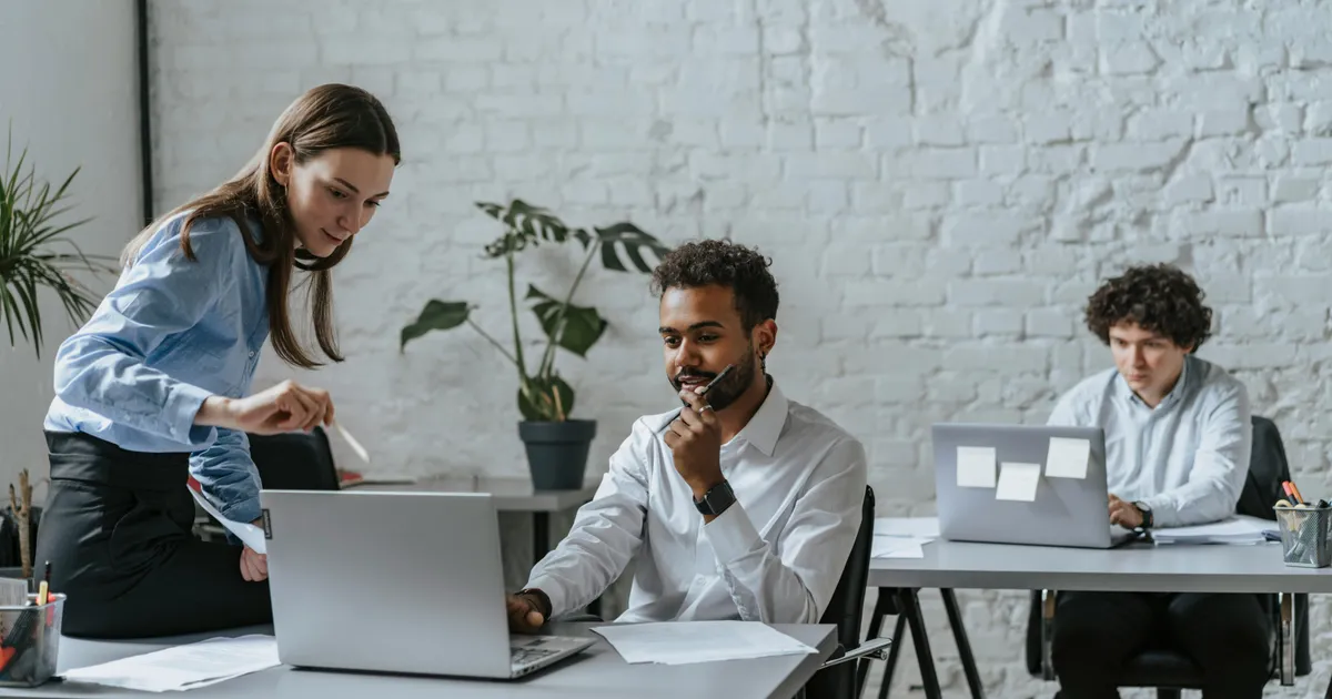 Business professionals discussing internet plans in a modern office setting.