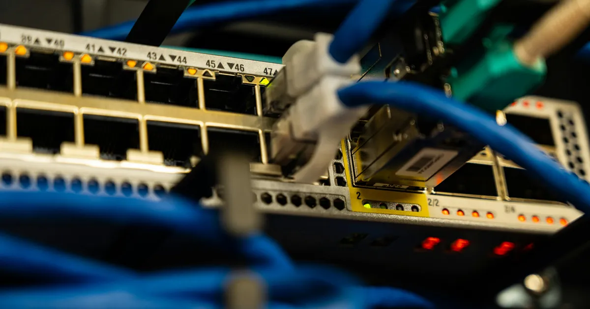 Close-up of a sleek Wi-Fi 6E router with glowing indicator lights.