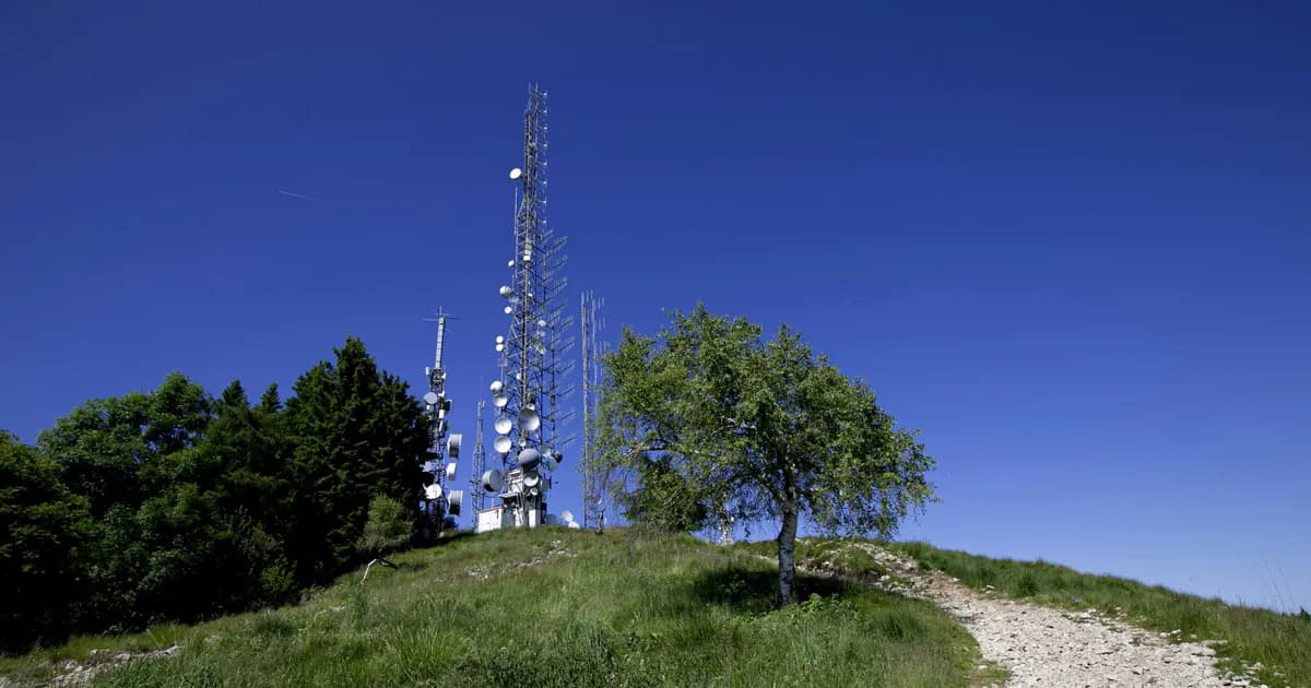 Rural landscape with tower and Wi-Fi signal waves.