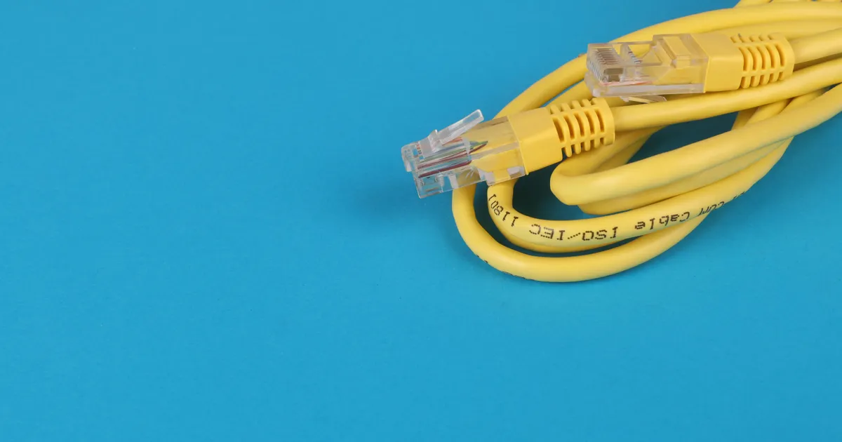 Comparison of cable and DSL modems on a wooden table.